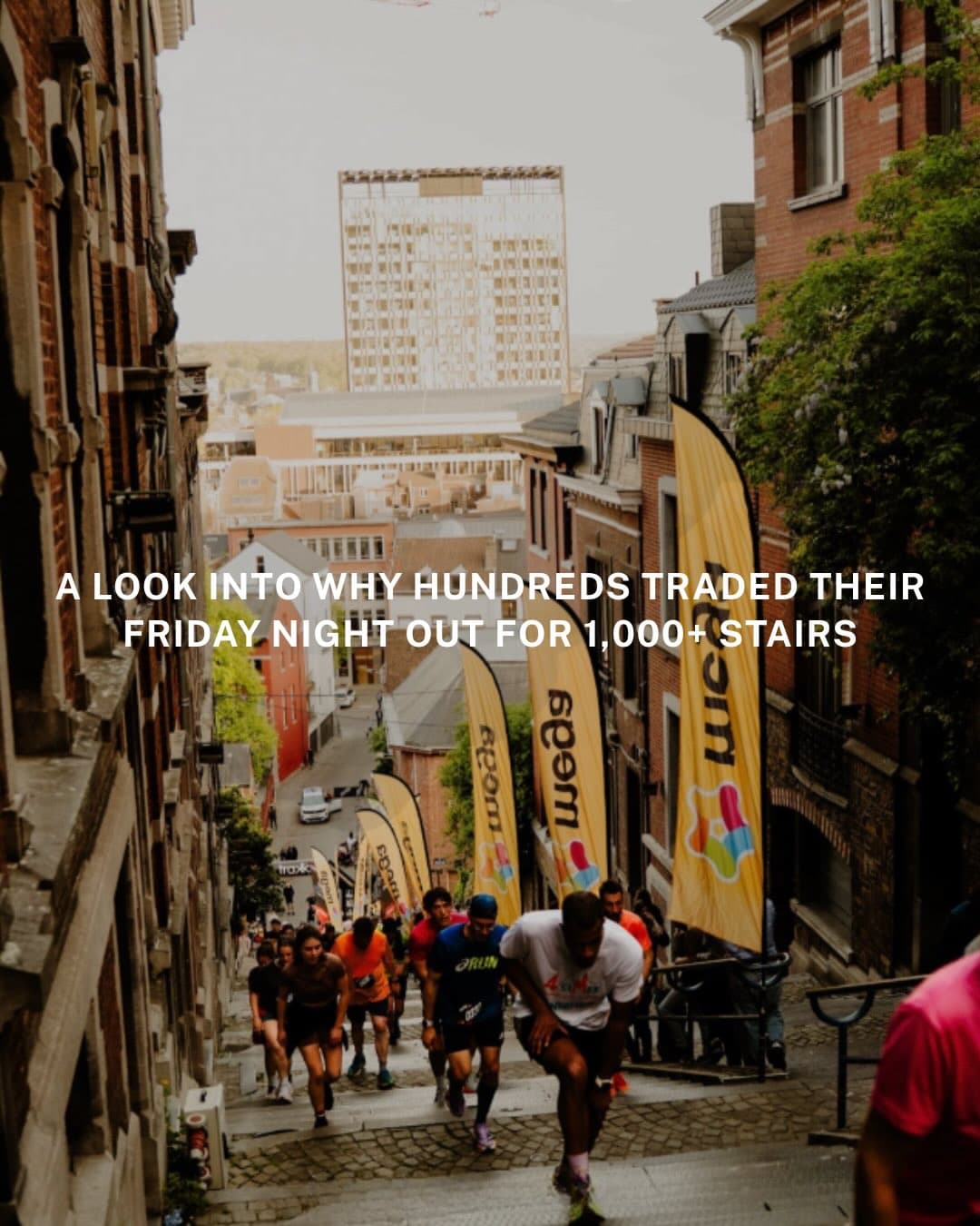 Runners gathered on and around the Montagne de Bueren staircase in Liège during a community running event, with crowds lining the historic stone steps