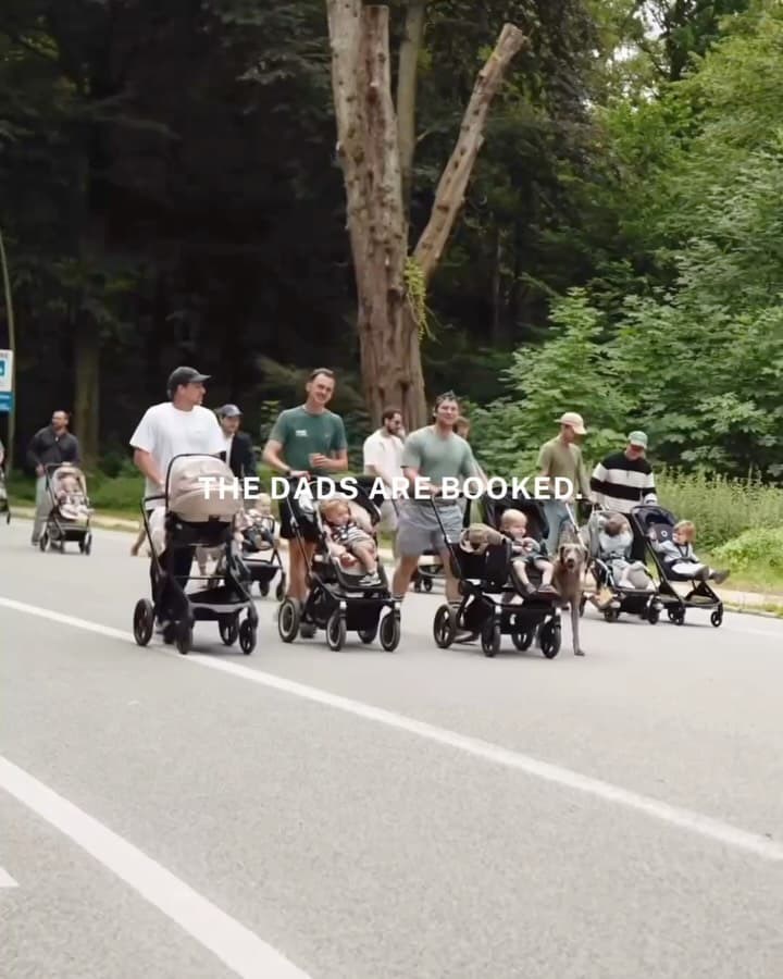 Fathers and children gathered at an outdoor community meetup organized by Daddy Cours