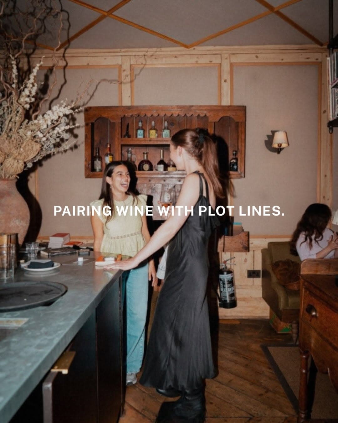 Guests at a Book Tasting event pairing books with wine glasses on a table