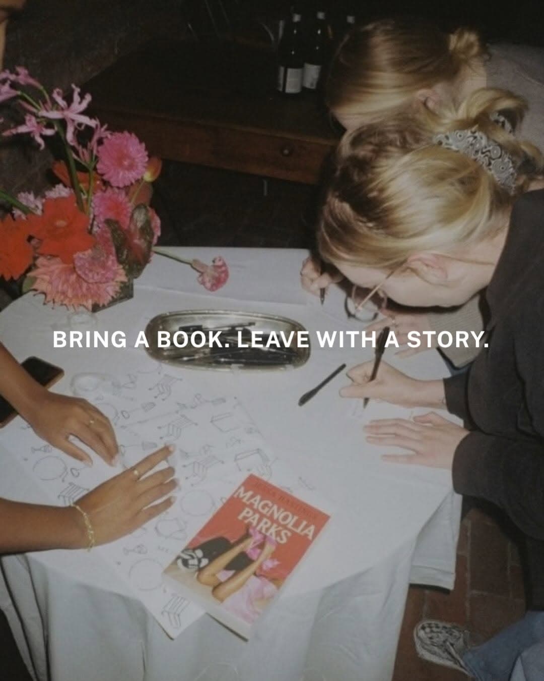 Guests seated at a long dinner table at Elliot's in London, sharing books during the Service95 Book Club and Club Sup Book Swap Supper.